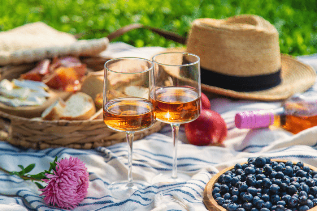 Deux verres de vin et de la nourriture pour un pique-nique romantique dans un jardin à Lyon